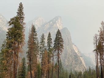 Mountain peaks shrouded in wildfire smoke.